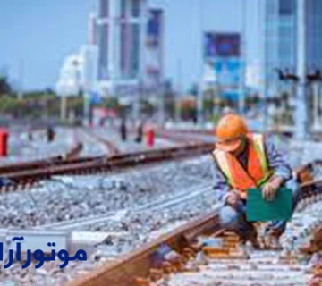 تصویر یک مهندس در حال بررسی ریل قطار